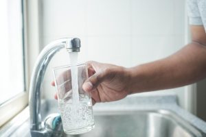 Get the benefits of a Tucson Non-Salt Water Softener with H2O Concepts image shows glass being filled in sink