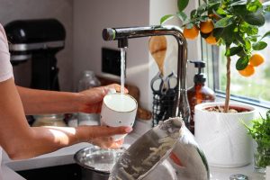 Address problems caused by Glendale Hard Water with help from H2O Concepts image shows dish being washed in sink