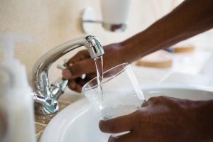 Address annoying Maricopa Hard Water issues with help from H2O Concepts image shows glass being filled in sink